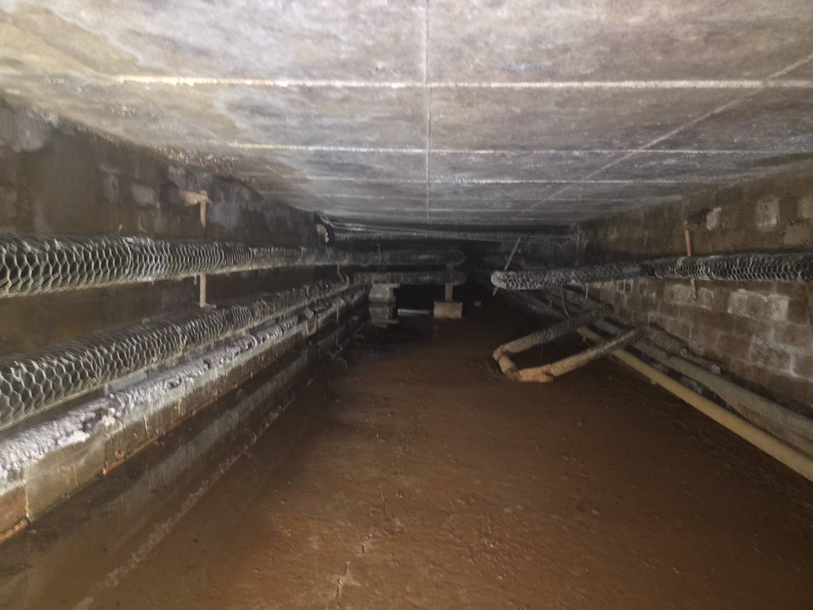 Cardinal Newman High School — lagged pipework and flange joint in the underground duct before the works — Innov8 UK Group